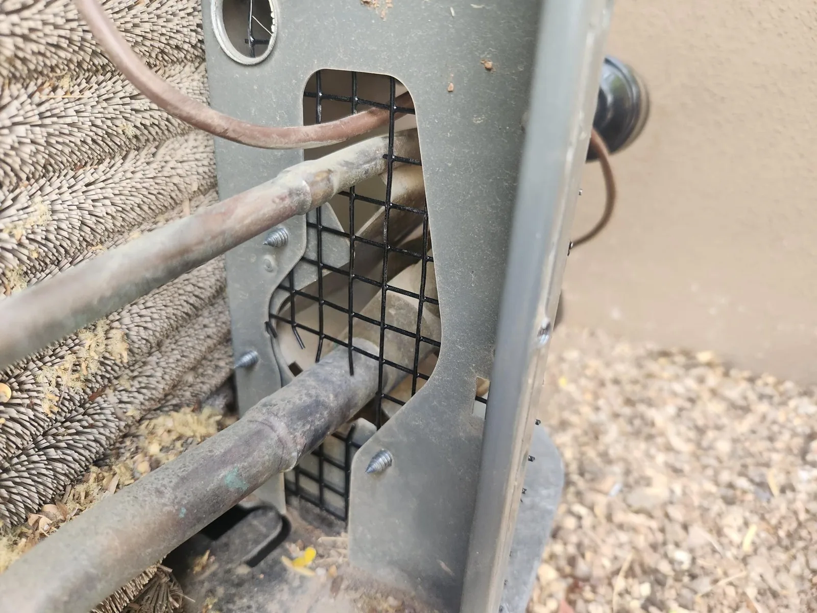 Wire mesh around the line set of an air conditioning unit