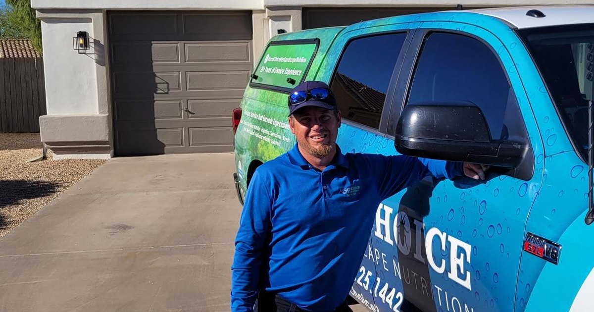 A Local Choice technician standing beside a company truck in a driveway